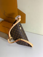 Louis Vuitton monogram crossbody bag with long tan strap, gold hardware, zip top