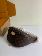 Louis Vuitton monogram crossbody bag with strap and flap, brown coated canvas, side view.