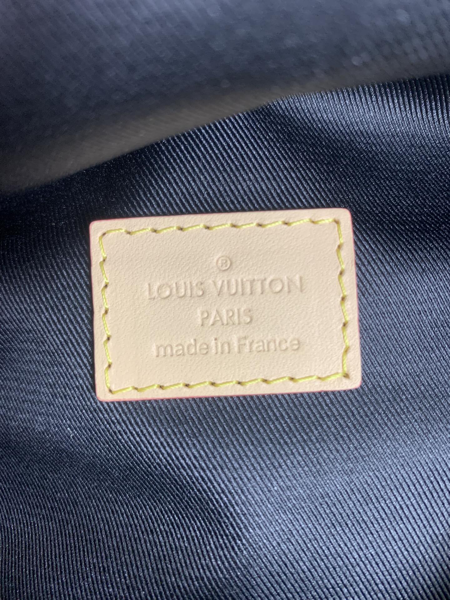 Louis Vuitton PARIS made in France label on dark fabric, stitched leather patch