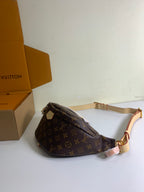 Louis Vuitton monogram crossbody bag with adjustable strap and gold hardware, brown, side view.