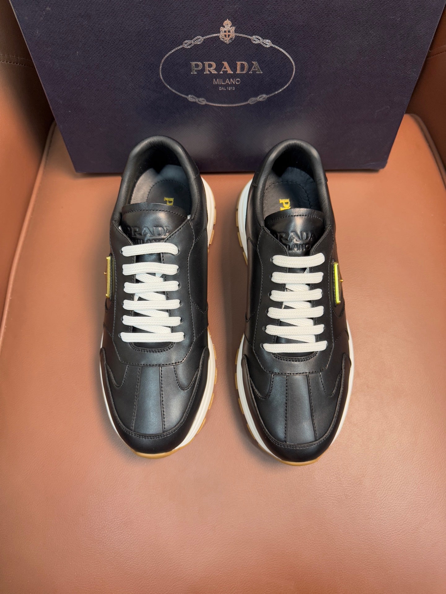 PRADA low-top sneakers, dark leather with white laces and contrasting sole