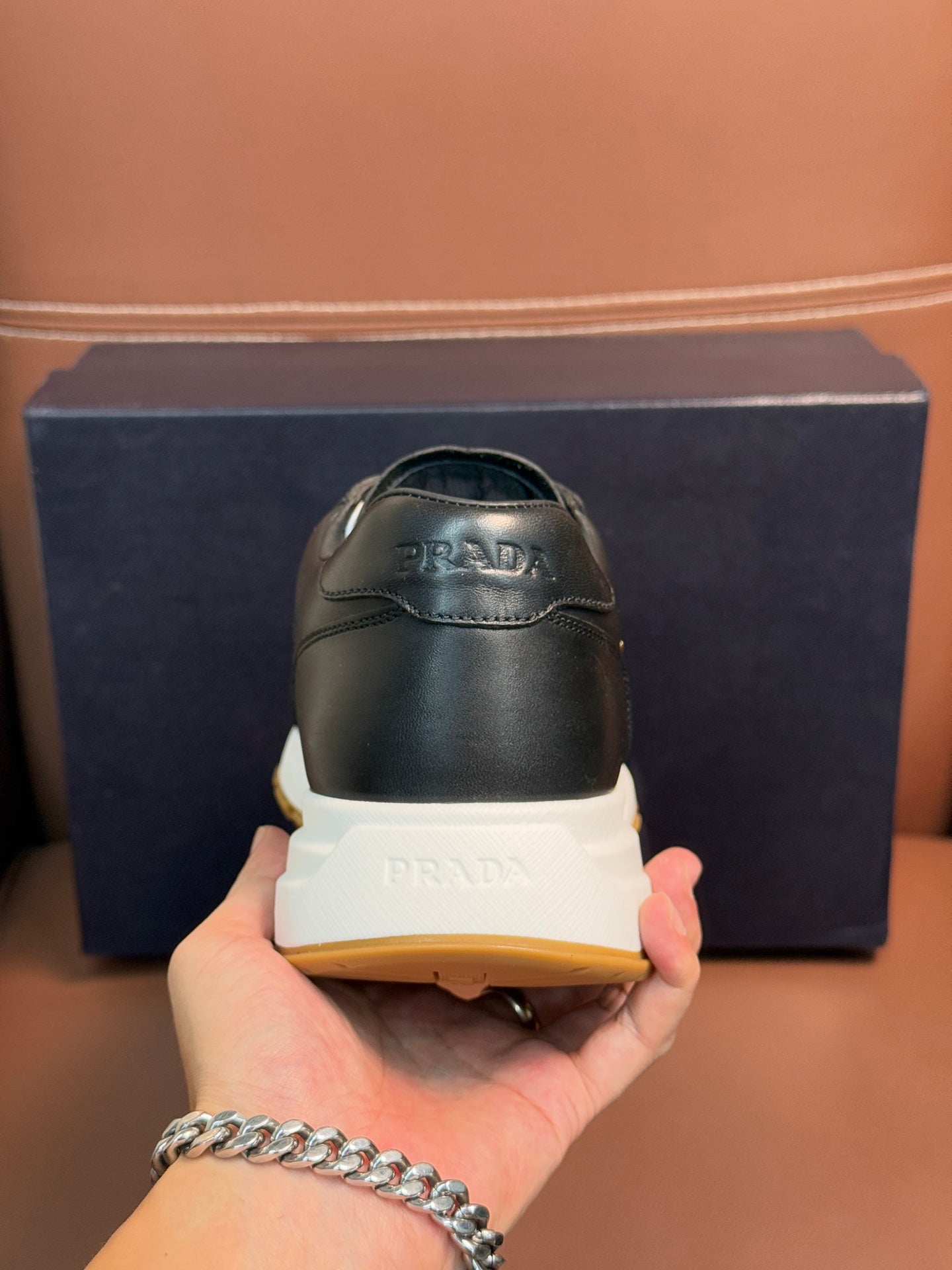 PRADA low-top sneakers heel, dark leather with white midsole and yellow outsole