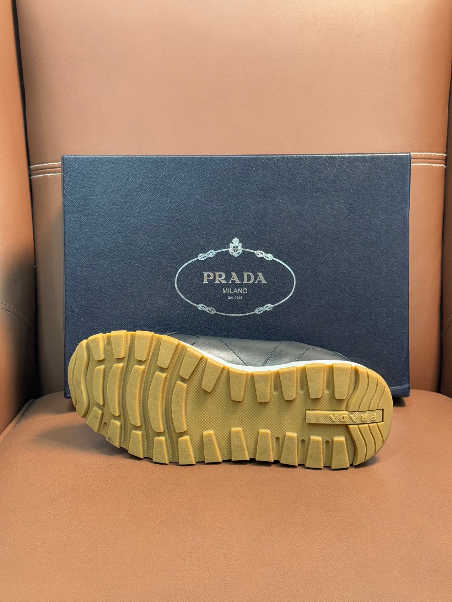PRADA sneaker outsole, yellow tread rubber with PRADA mark on heel