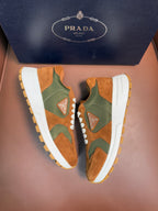 Unisex Prada sneakers, tan and green suede with white rubber sole and lace-up front.