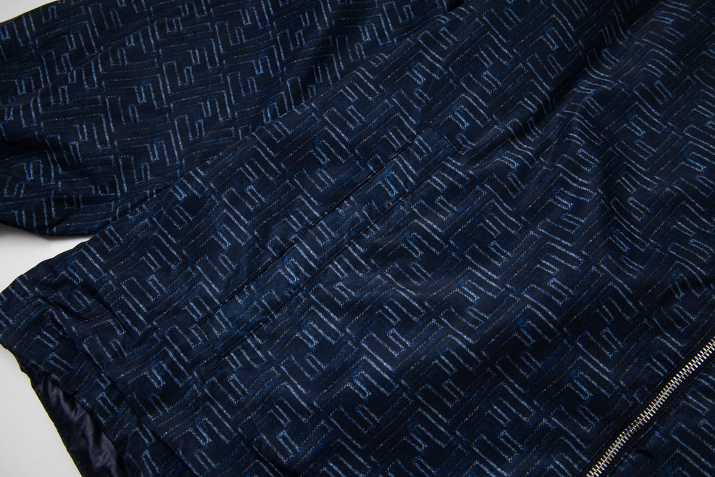 Navy jacket with all-over geometric pattern and front zipper edge