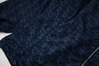 Navy jacket with all-over geometric pattern and front zipper edge