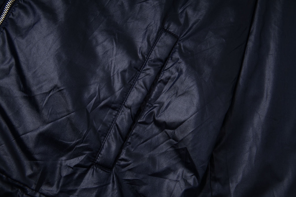 Navy hooded jacket fabric with seam lines and diagonal quilting