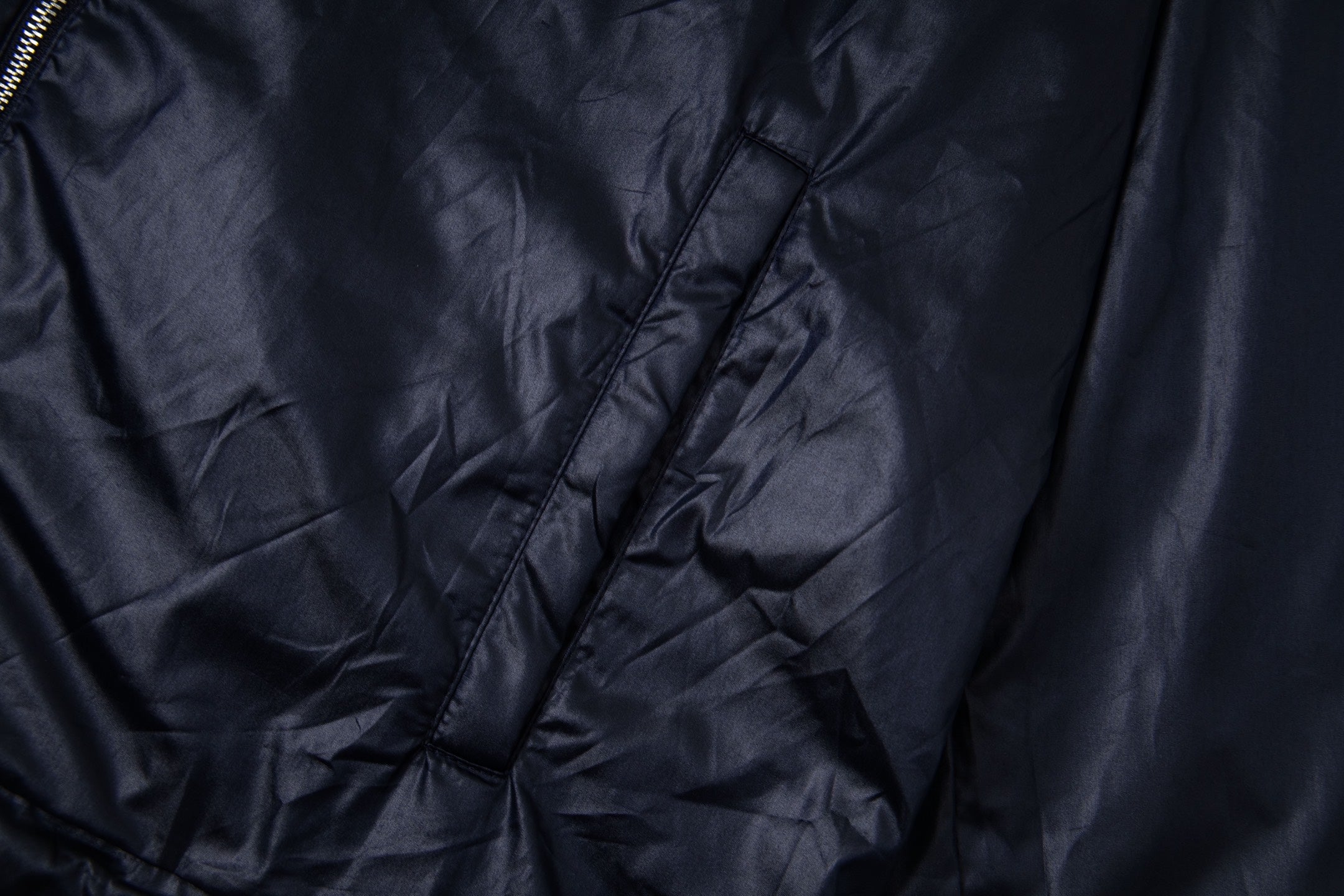 Navy hooded jacket fabric with seam lines and diagonal quilting