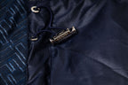 Navy jacket front with snap and zipper pull, metal logo tab