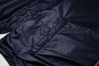 Navy hooded jacket with diamond quilting stitch detail and diagonal paneling