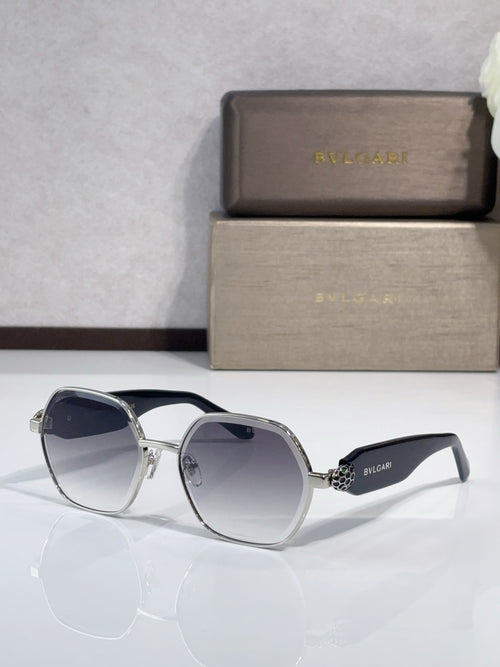 Blue-tinted sunglasses with dark frames and gold-tone logo accents