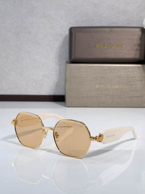 Amber-tinted sunglasses with gold round frames and light logo on arms