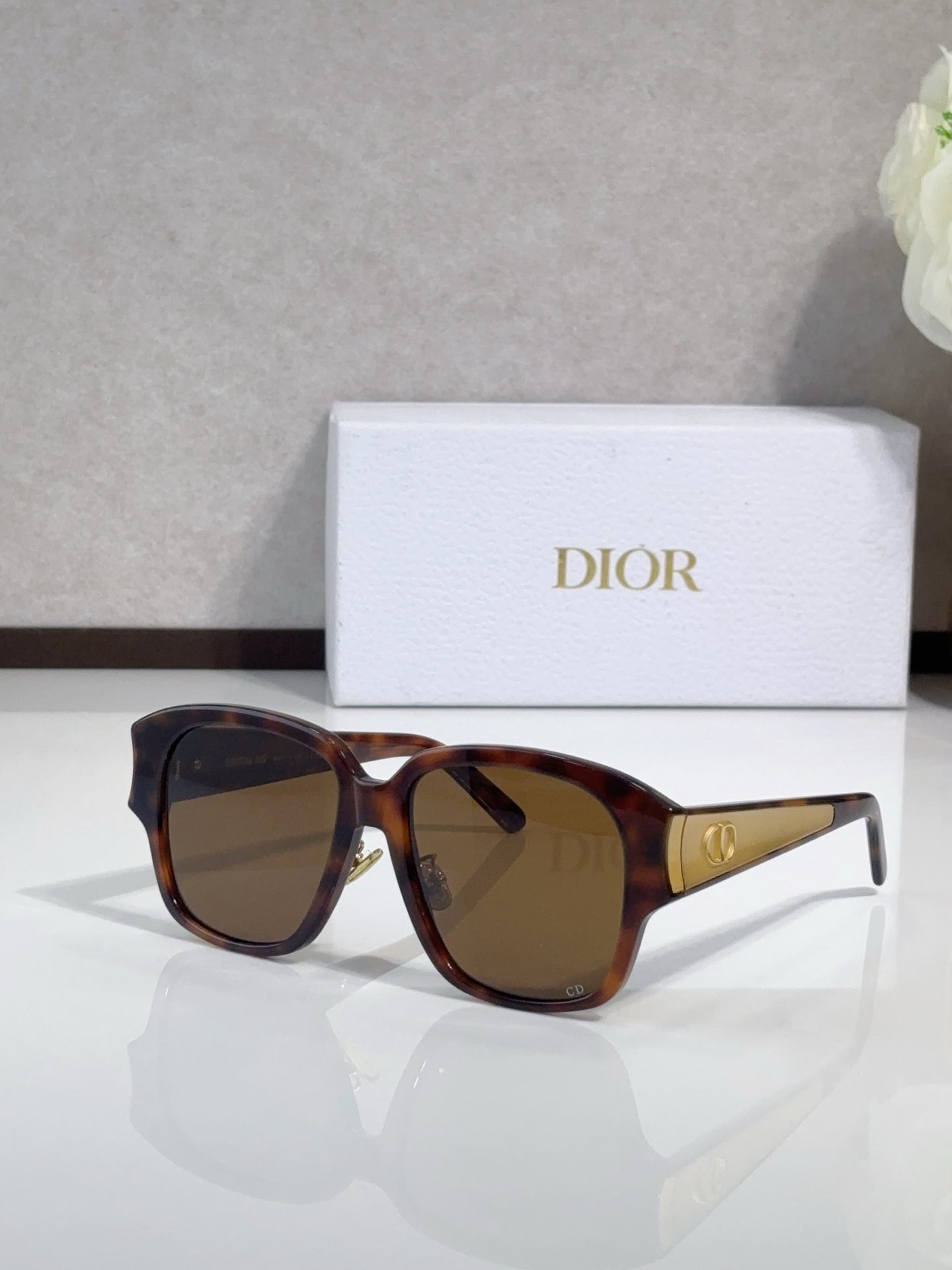 Dior sunglasses, brown tortoiseshell frame with dark lenses and gold bridge detail