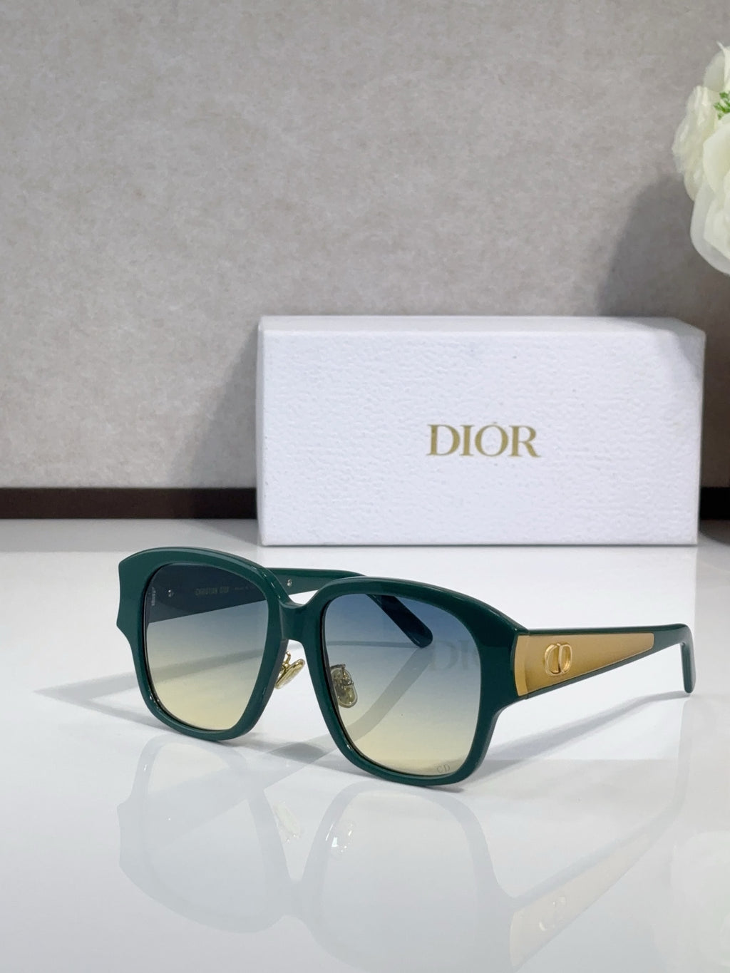 Dior sunglasses, green frame with pale lenses and gold bridge logo detail