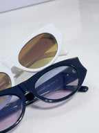 Dior sunglasses close-up, white and navy frames with tinted lenses