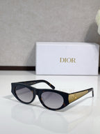 Dior sunglasses, dark frames with gold logo temples and clear-lens gradient tint