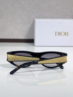 Dior sunglasses, dark frames with gold logo accents and tinted lenses