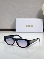 Dior sunglasses, black frames with gold logo temples and pink-tinted lenses