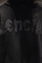Balenciaga long zip-up hoodie chest graphic with snap buttons near shoulder seam.