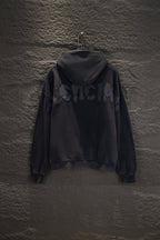 Balenciaga long zip-up hoodie, dark with hood and raised graphic text on the back.