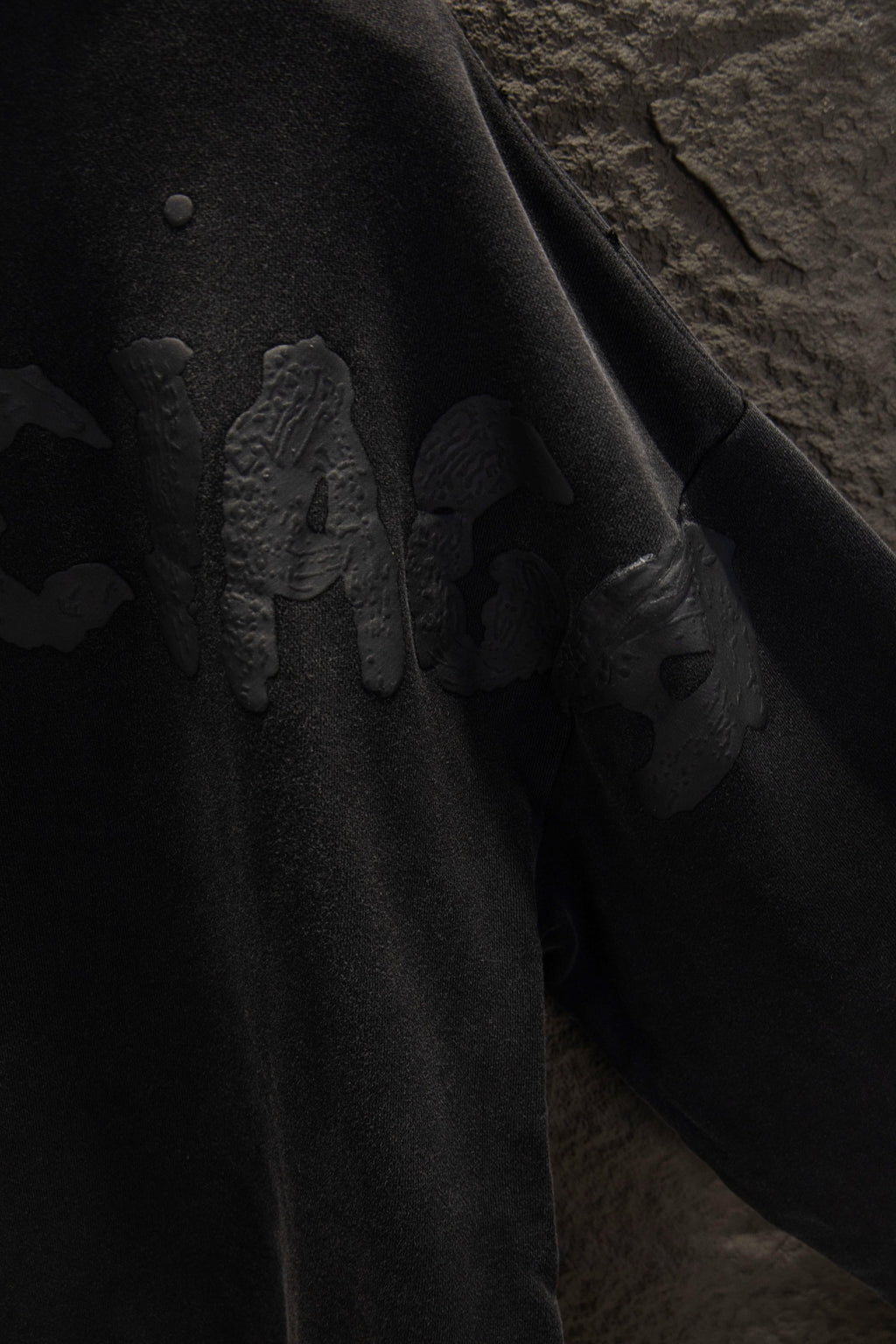 Balenciaga long zip-up hoodie sleeve close-up with embossed graphic design.
