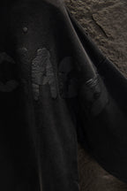 Balenciaga long zip-up hoodie sleeve close-up with embossed graphic design.