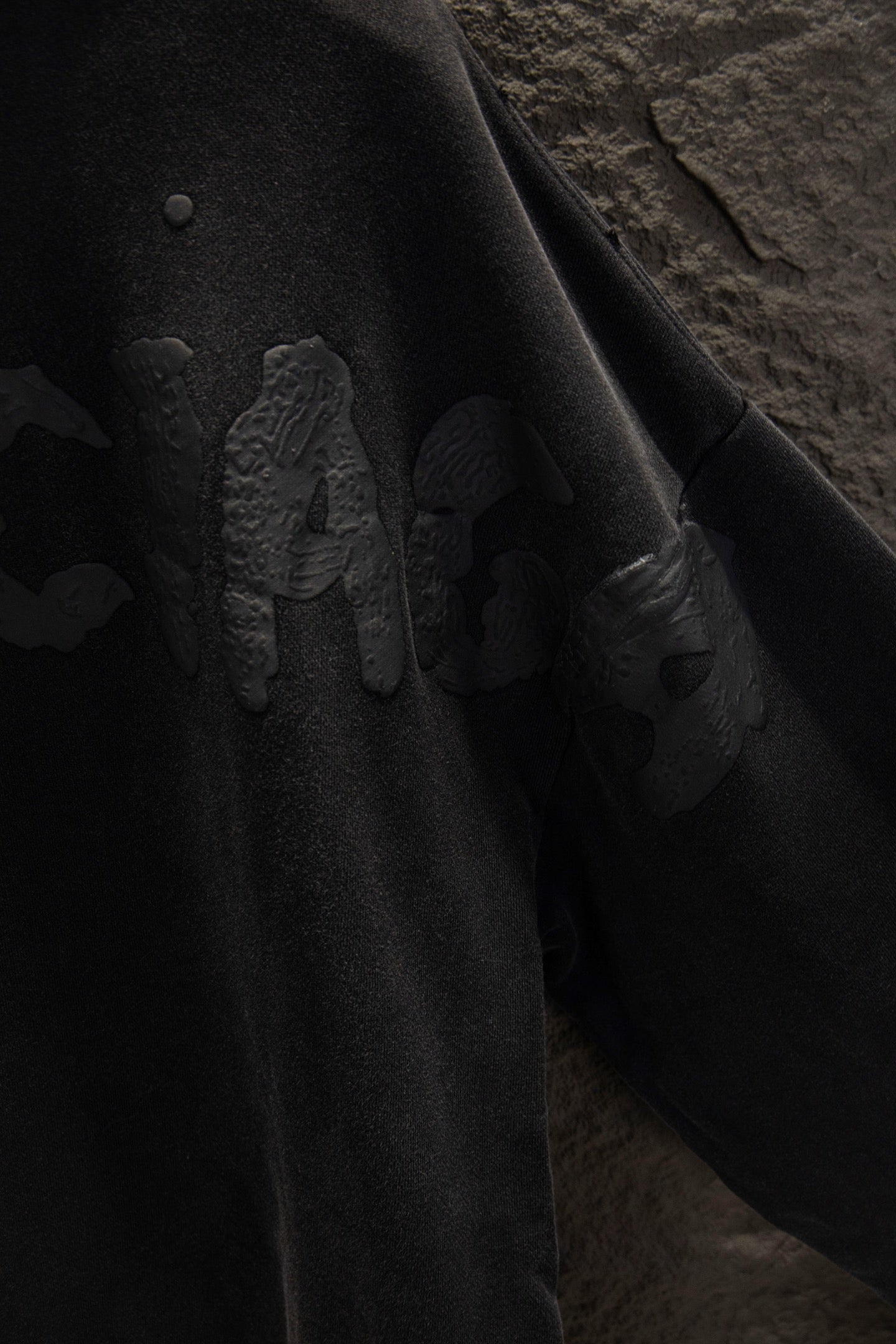 Balenciaga long zip-up hoodie sleeve close-up with embossed graphic design.