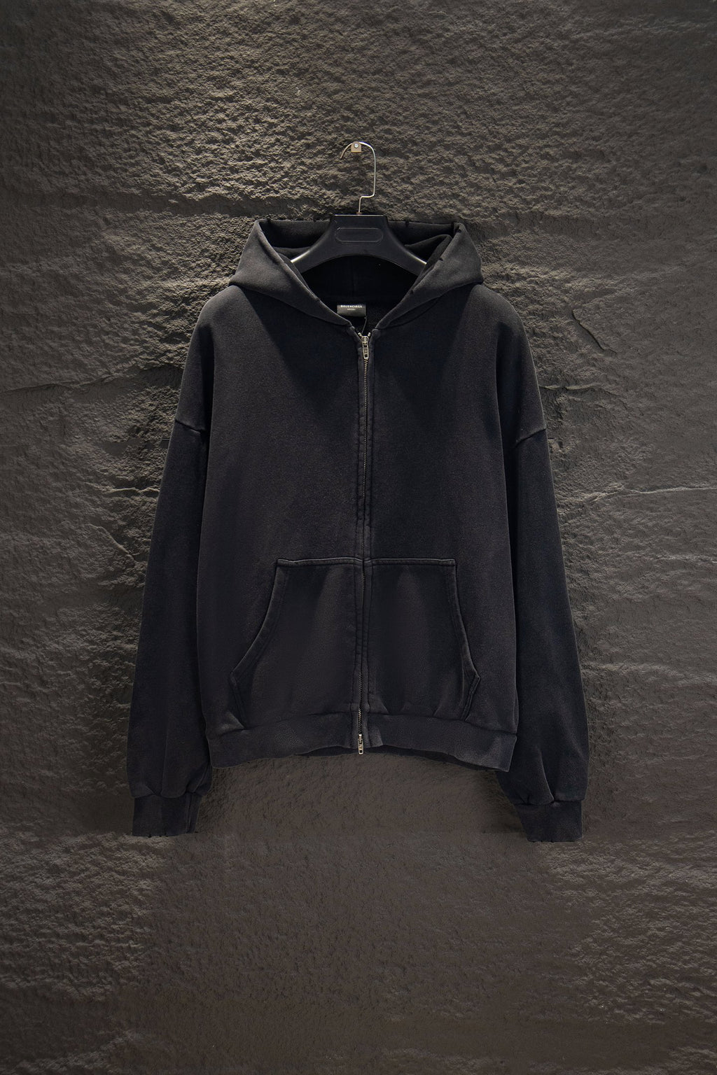 Balenciaga long zip-up hoodie, dark with hood, front zipper, and kangaroo pocket.