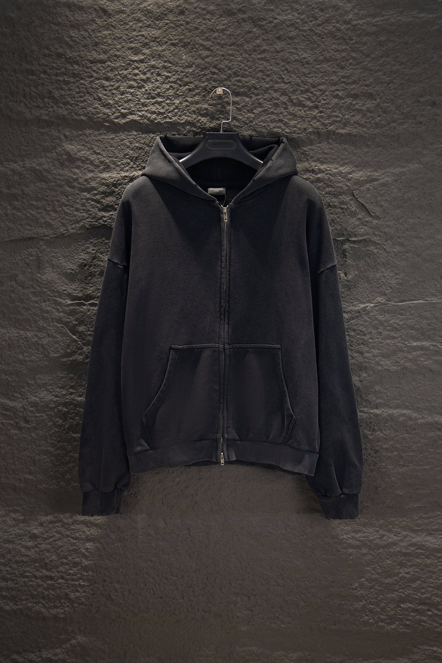 Balenciaga long zip-up hoodie, dark with hood, front zipper, and kangaroo pocket.