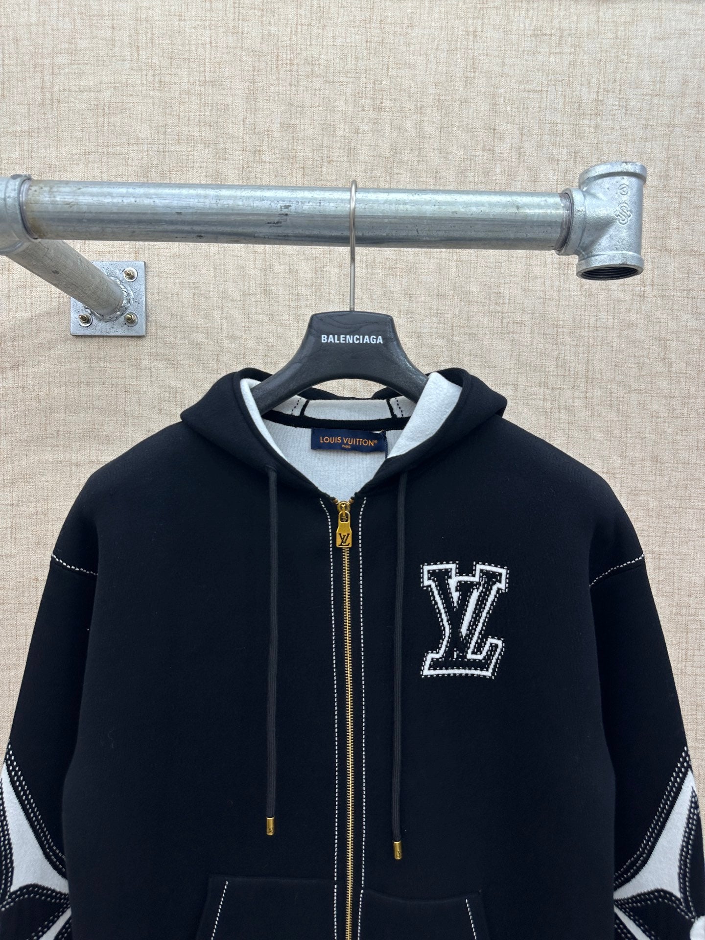Zip-up hoodie with hood, gold zipper, and white LV-style logo on the chest