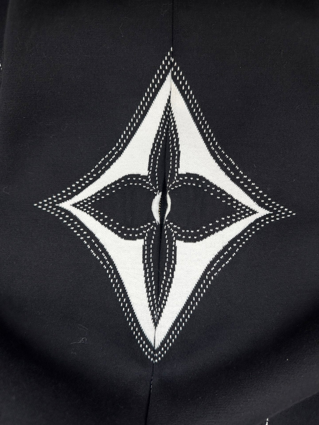 Black hoodie with large white diamond motif and central logo graphic