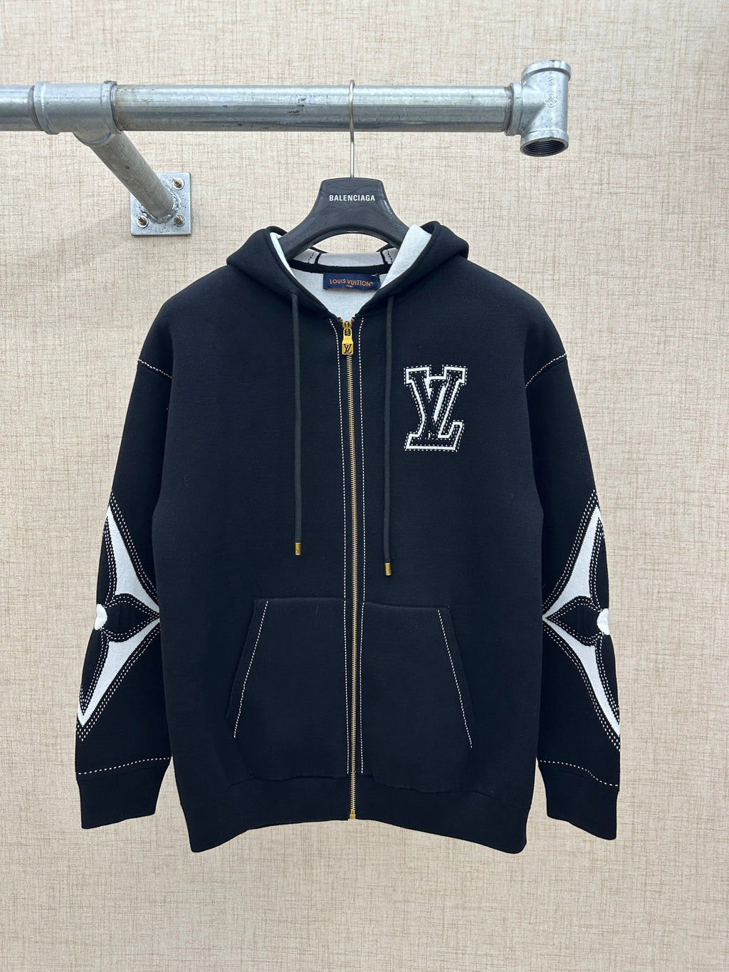 Zip-up hoodie with hood, dark knit, gold zipper, and LV-style chest logo patch