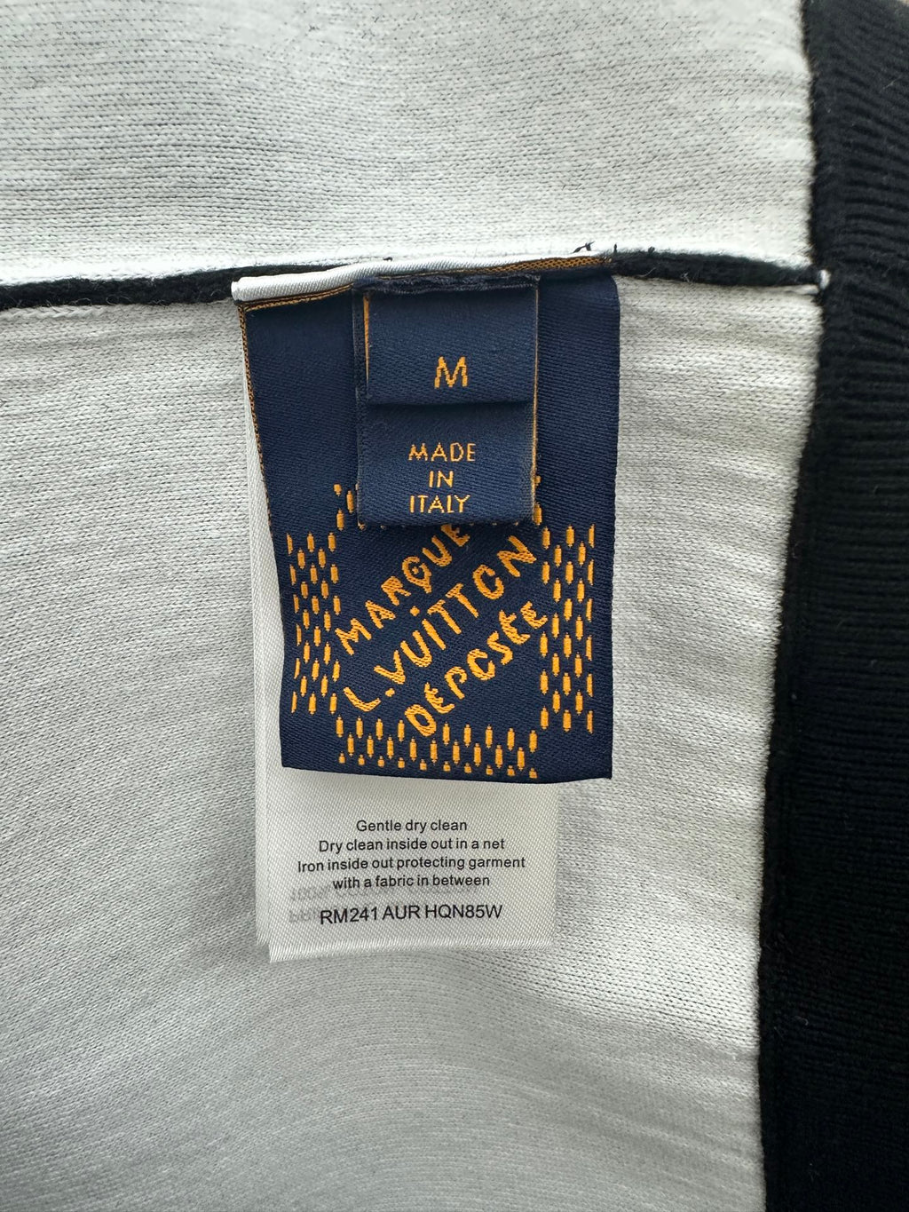 Hoodie clothing label: size M, Made in Italy, and care instructions