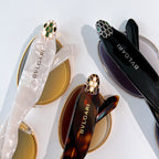 Assorted sunglasses: gold frame with amber lenses and black frame with dark lenses