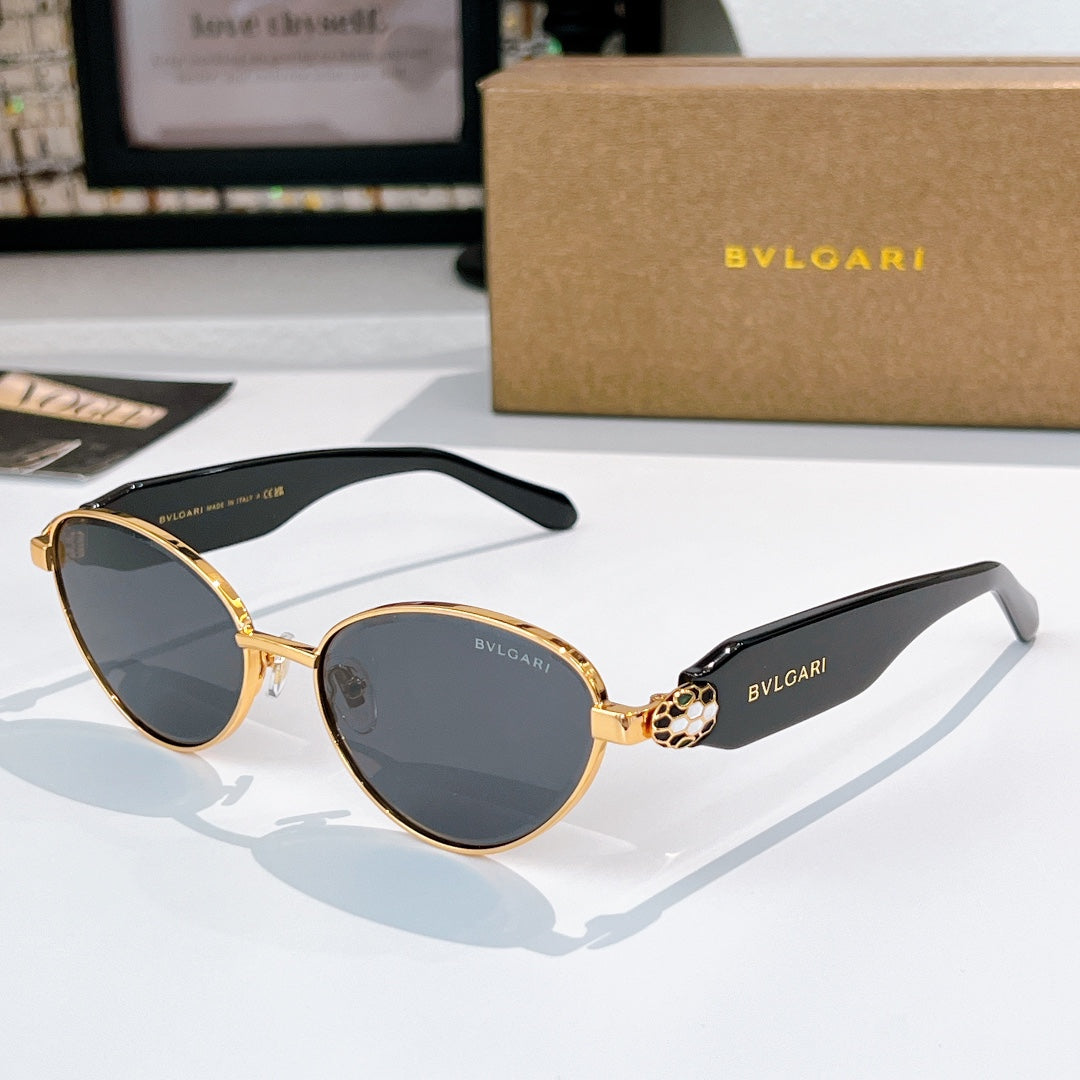 Gold-trim round sunglasses with dark lenses and black temple arms with logo
