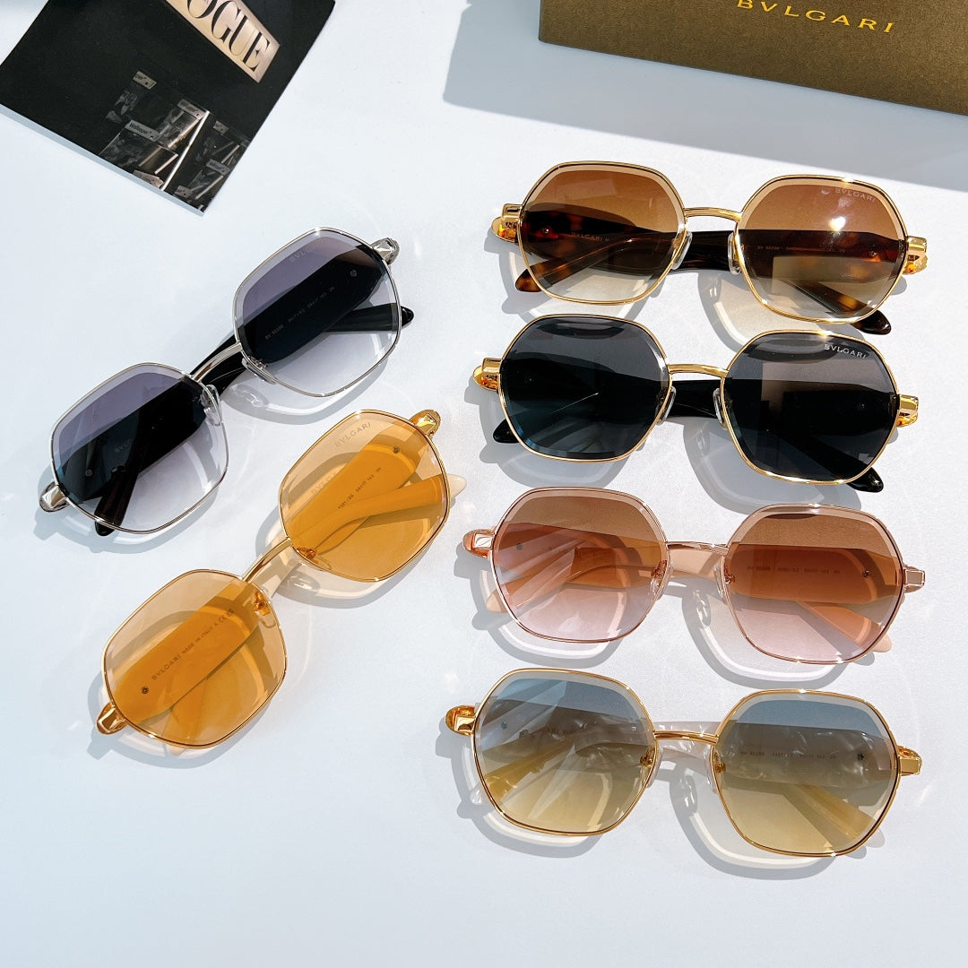 Assorted sunglasses with gold-tone frames and dark, amber, and brown lenses