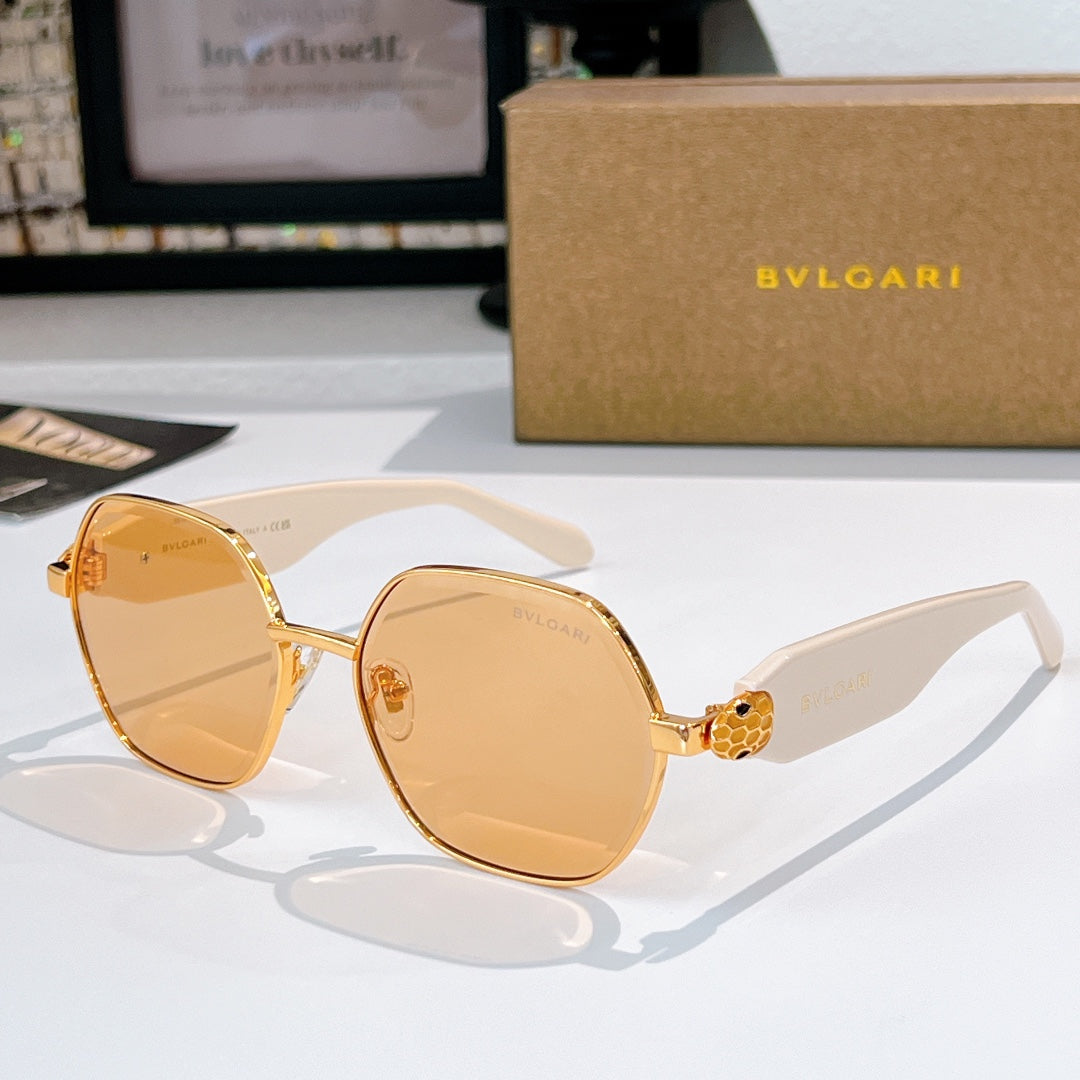 Gold-tone round sunglasses with amber lenses and white temple arms