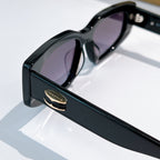 Bvlgari sunglasses, black frame with purple-tinted lenses, side view