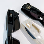Bvlgari sunglasses, black and white frames with gold logo hinge details