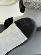 Light gray suede ankle boot with black side panel and subtle embroidered logo