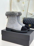 Light gray suede ankle boot with gray shearling cuff and black rubber sole