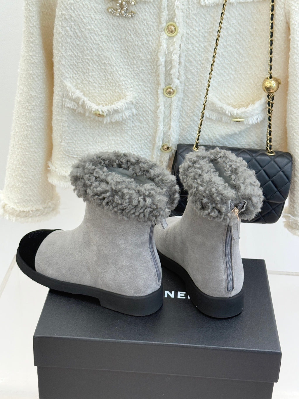 Light gray suede ankle boots with fuzzy gray cuffs and black side inserts