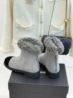 Light gray suede ankle boots with fuzzy gray cuffs and black side inserts