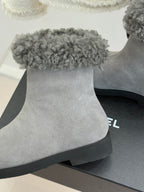 Light gray suede ankle boot with wide gray shearling cuff and black sole edge