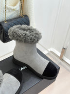 Light gray suede ankle boot with gray shearling cuff and black toe panel