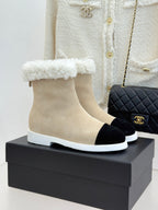 Chanel ladies beige suede ankle boots with black toe and white sole, fuzzy trim