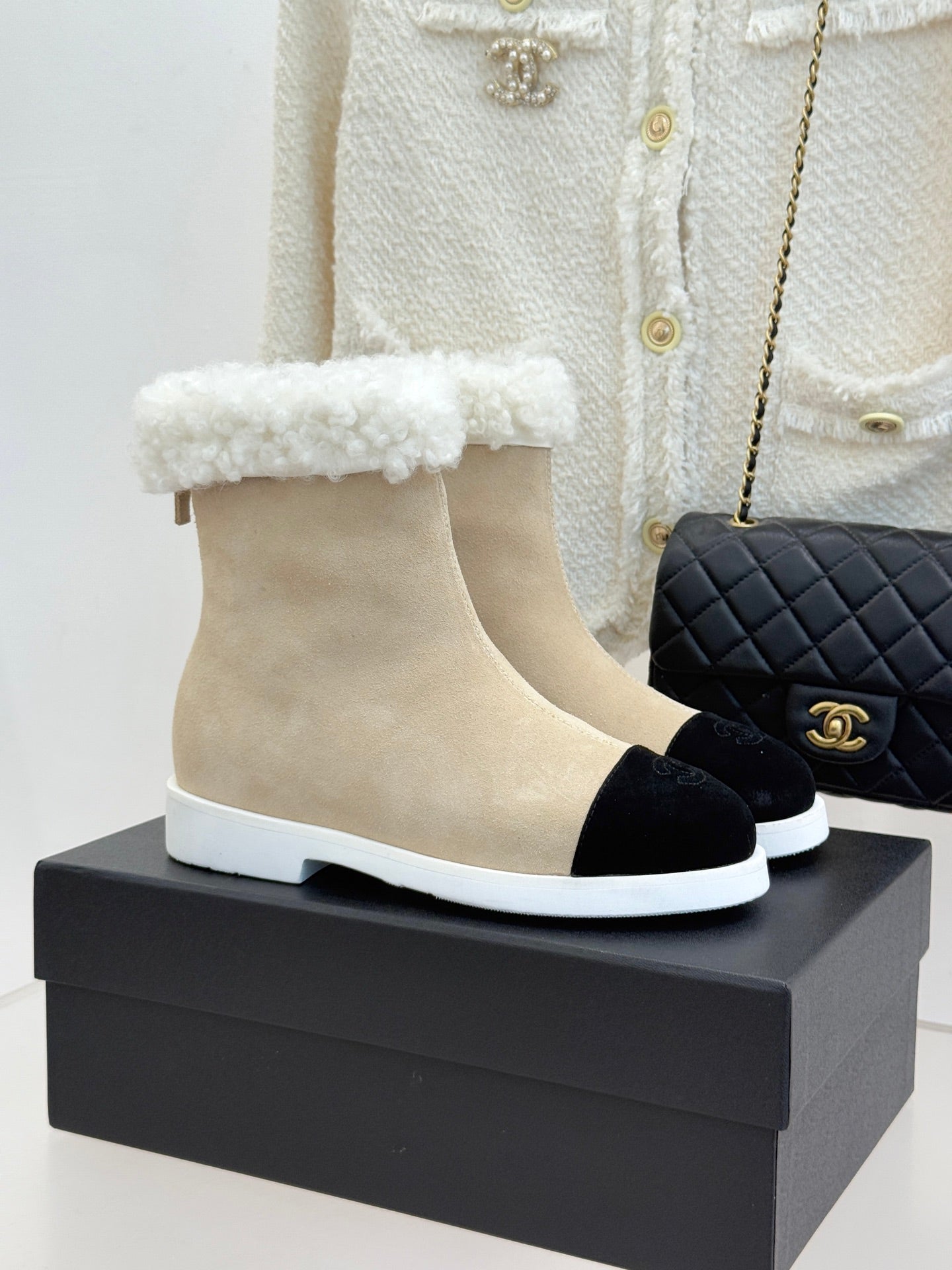 Chanel ladies beige suede ankle boots with black toe and white sole, fuzzy trim