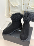 Black suede ankle boots with faux-fur cuffs and side logo embroidery