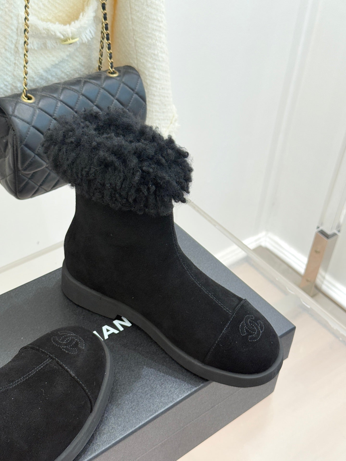 Black suede ankle boots with faux-fur cuffs and chunky rubber sole