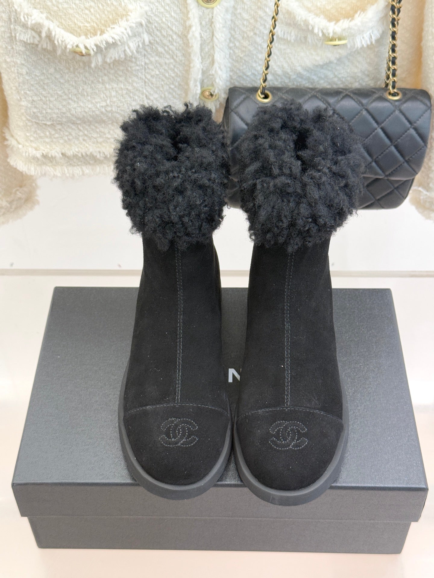 Pair of black suede ankle boots with faux-fur cuff detail and rubber sole